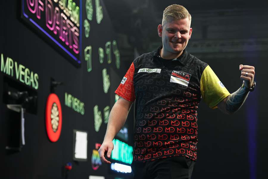 Mike De Decker celebrates after beating Michael Smith at the Grand Slam of Darts