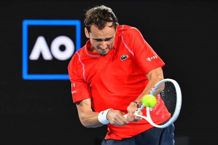 Russia's Daniil Medvedev hits a return against Australia's John Millman