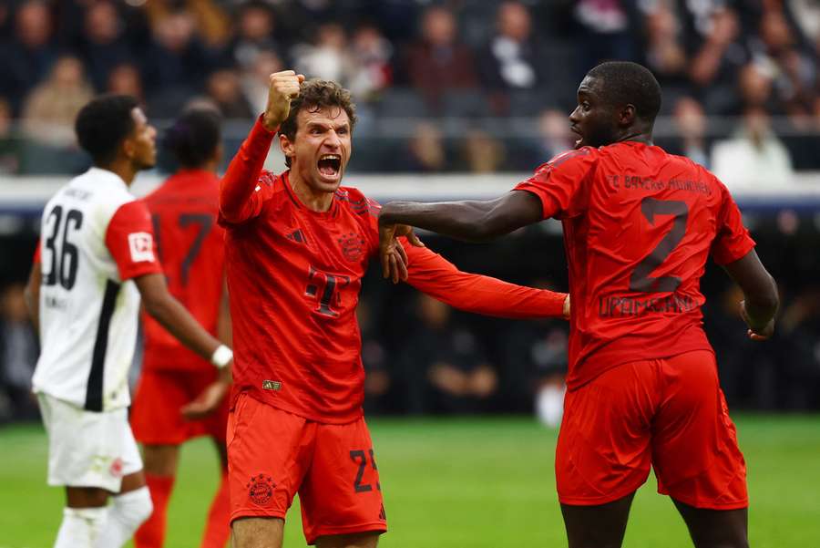 Bayern Munich's Dayot Upamecano (right) celebrates a goal with Bayern Munich's Thomas Muller