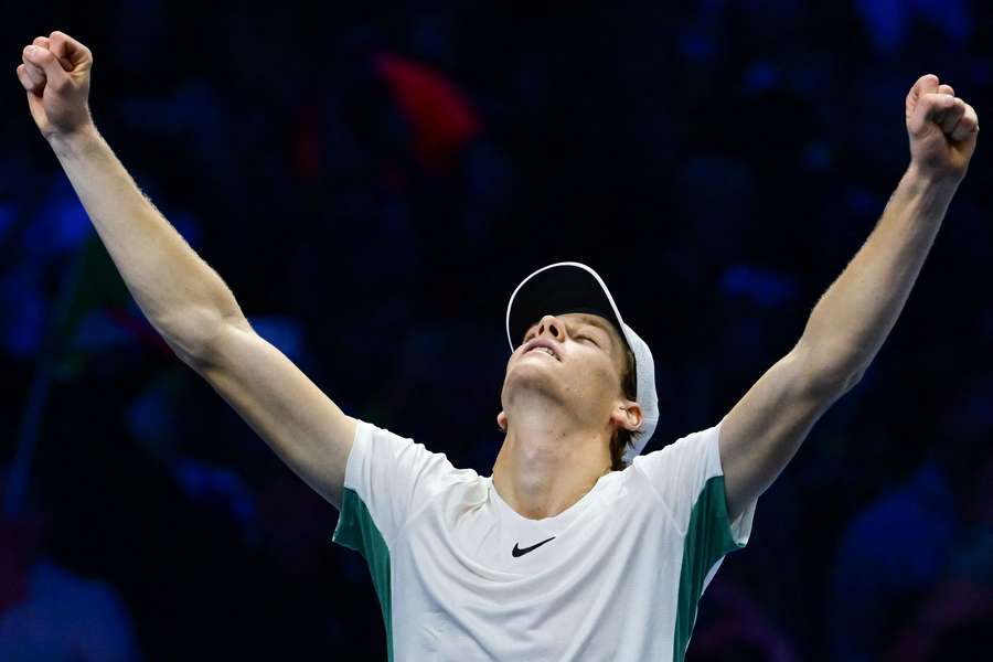 Jannik Sinner celebrates after winning his round-robin match against Novak Djokovic