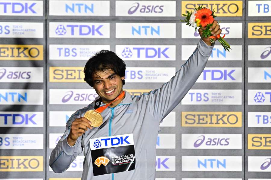 Neeraj Chopra celebrates on the podium with his medal in Budapest