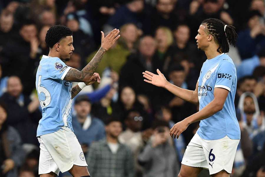 Man City's Nathan Ake shakes Savinho's hand