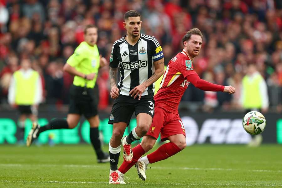 Liverpool's Alexis Mac Allister and Newcastle's Bruno Guimaraes challenge for the ball
