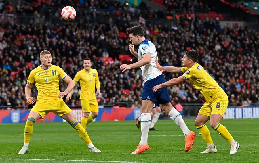 England's defender Harry Maguire heads towards goal