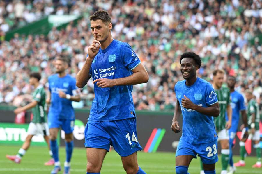 Schick (centre) celebrates scoring for Leverkusen