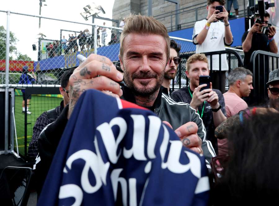 Sir David Beckham signs shirts for fans at the Brooklyn Bridge park fanzone
