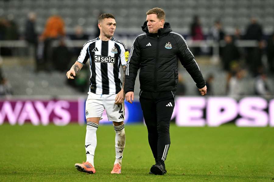 Trippier walks alongside Howe (R)