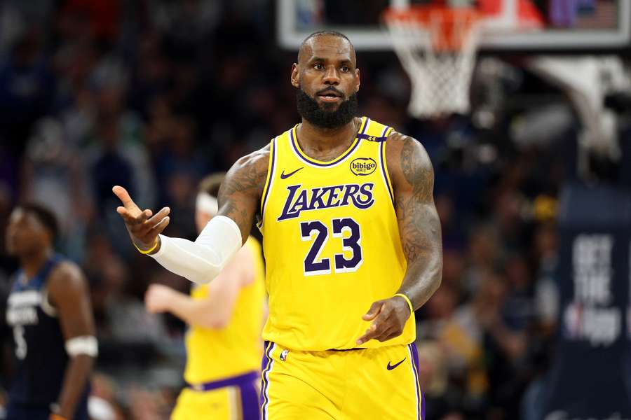 LeBron James of the Los Angeles Lakers celebrates his three-point basket against the Minnesota Timberwolves