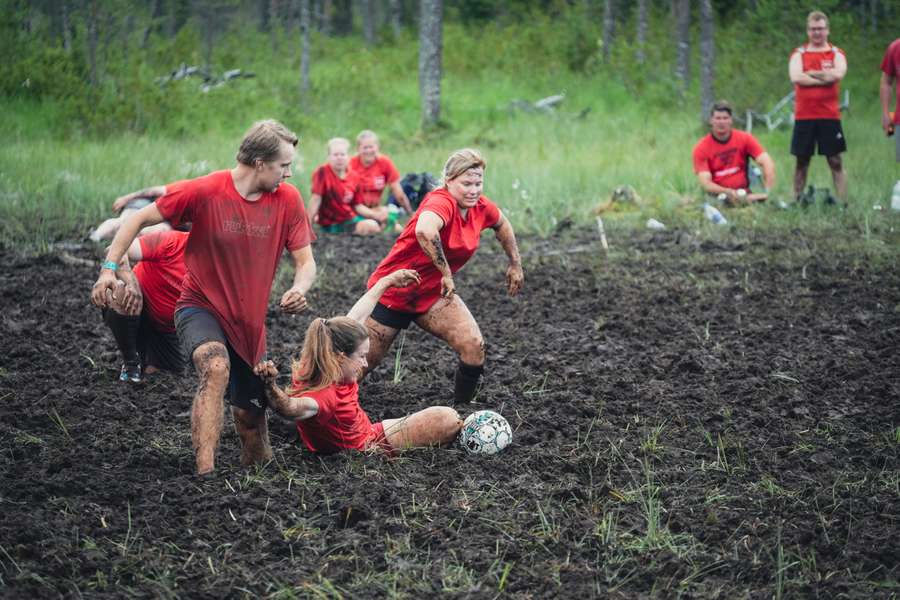 Players vie for the ball during a match of swamp soccer on July 15, 2023 at the Swamp Soccer World Cup