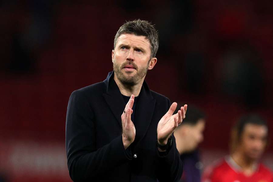 Michael Carrick applauds the supporters