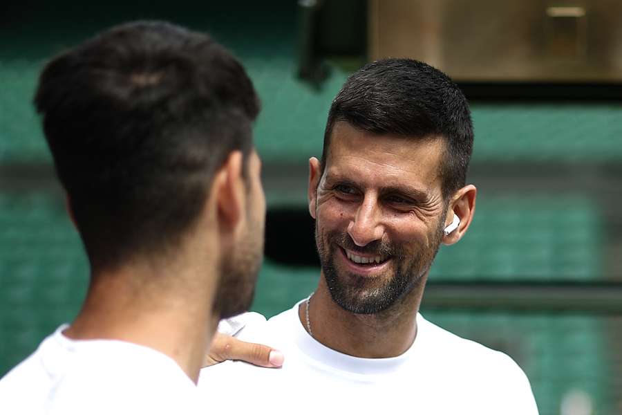 Serbia's Novak Djokovic smiles at Spain's Carlos Alcaraz during a warm up session