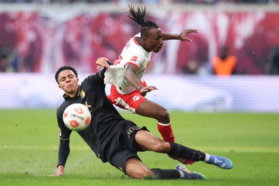 Augsburg's Noahkai Banks puts a challenge in on Leipzig's Yan Diomande