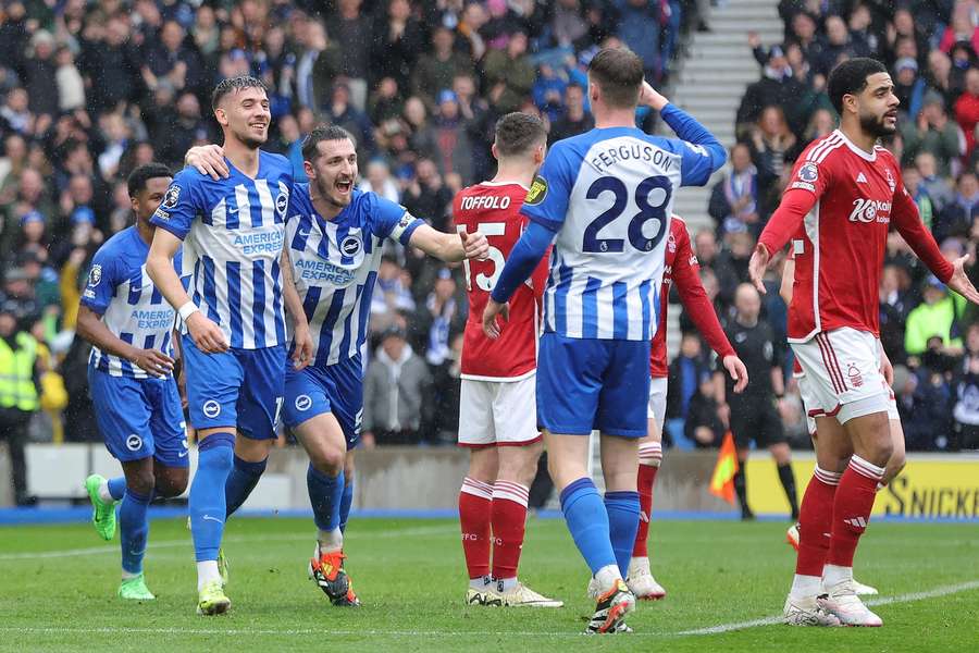 Jakub Moder (L) and Lewis Dunk (2nd L) of Brighton and Hove Albion celebrate