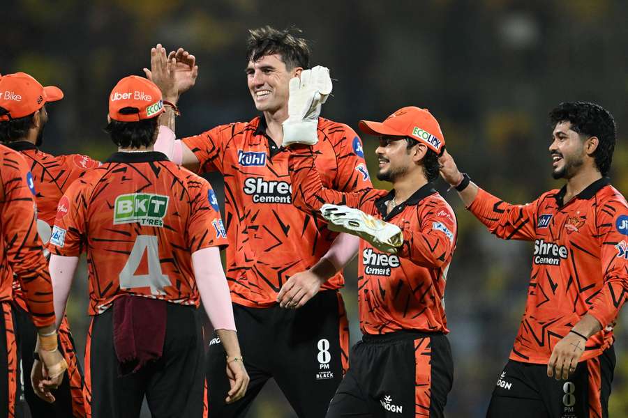 Sunrisers Hyderabad captain Pat Cummins celebrates a wicket with his teammates. 