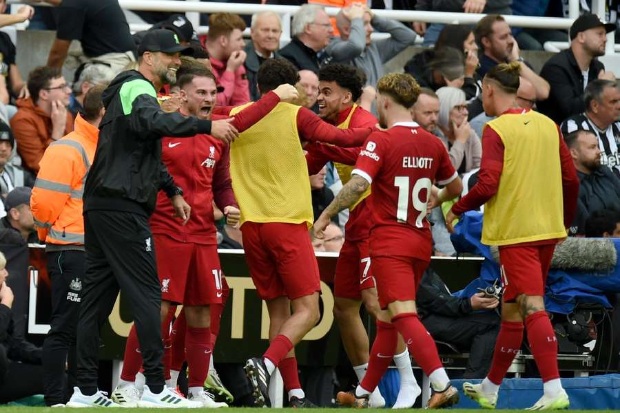 The Liverpool bench celebrate their win