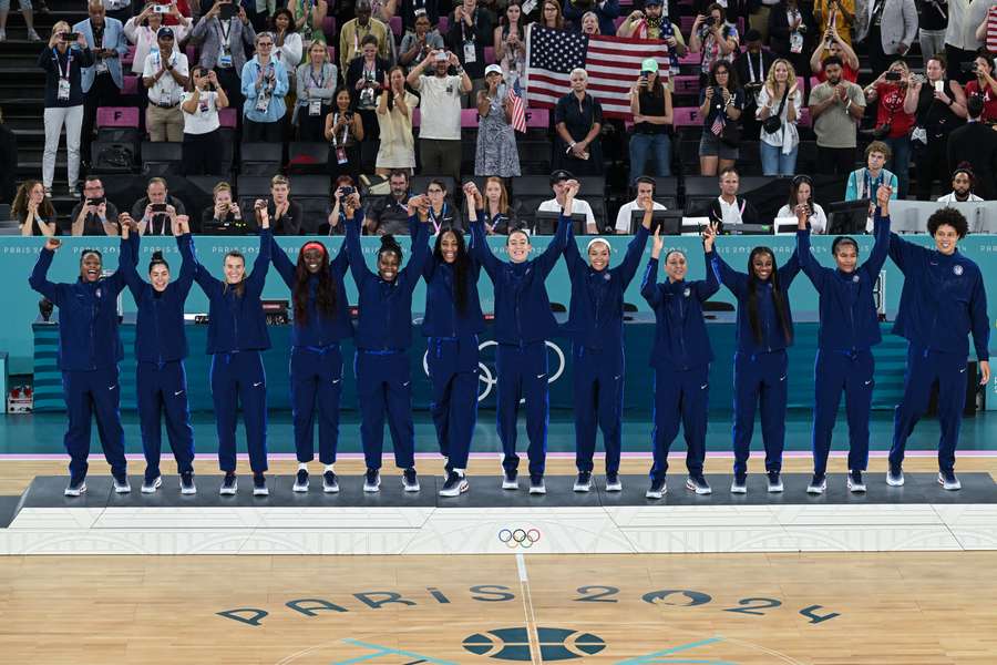 The USA's women's basketball team celebrate their gold medal win