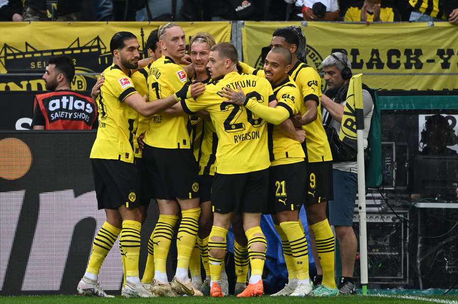 Dortmund's German forward Karim Adeyemi (hidden) celebrates scoring the opening goal with his teammates