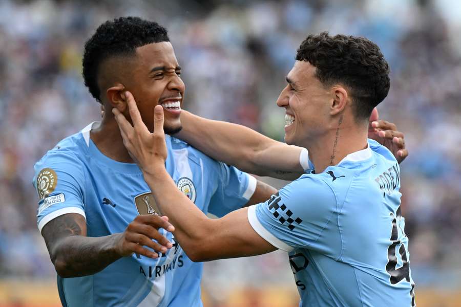 Savinho (left) and Phil Foden celebrate a goal for Man City