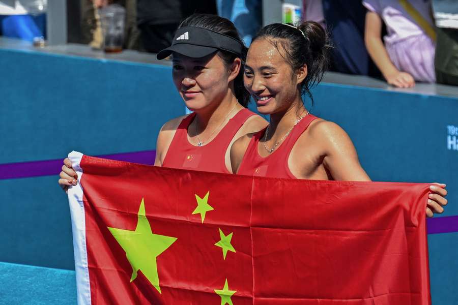 Qinwen Zheng of China (R) poses with second-placed compatriot Lin Zhu