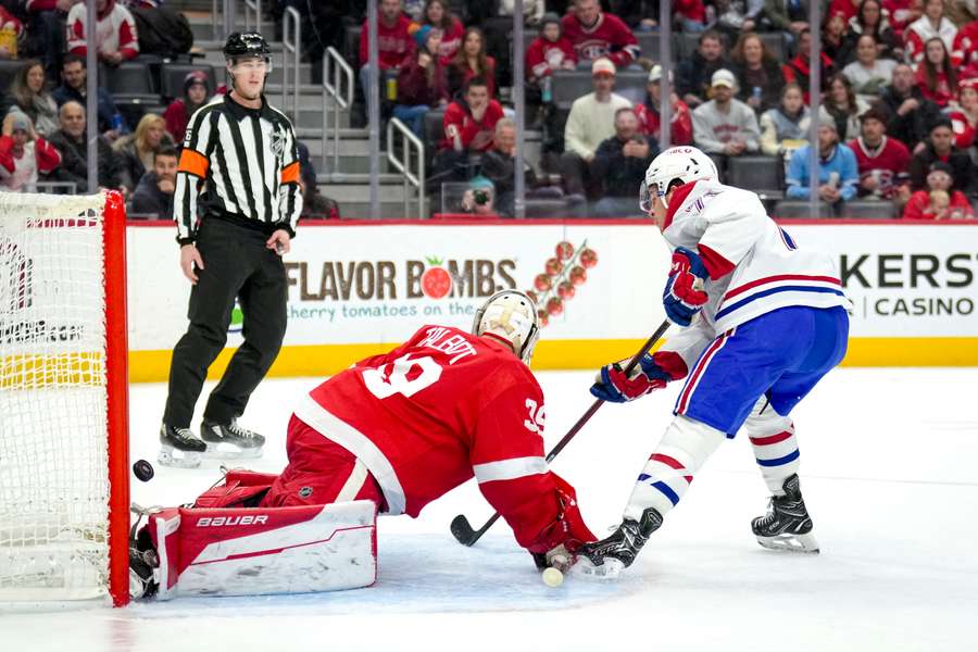 Jake Evans of the Montreal Canadiens scores a goal against Cam Talbot of the Detroit Red Wings during the first period