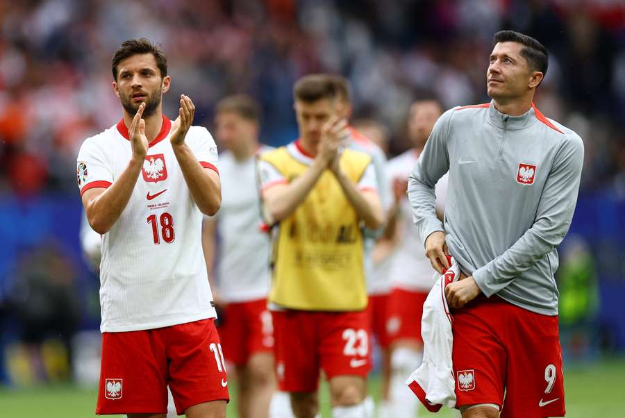 Poland's Bartosz Bereszynski and Robert Lewandowski applaud fans after the match