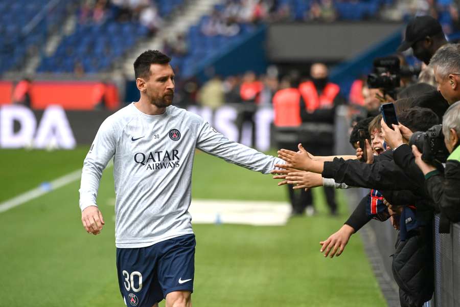 Paris Saint-Germain's Argentine forward Lionel Messi greets supporters during a warm up session