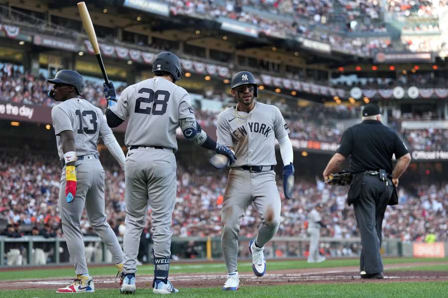 Jazz Chisholm Jr. (left), Austin Wells (middle), and Jose Caballero (right) celebrate after scoring during Opening Day 2026
