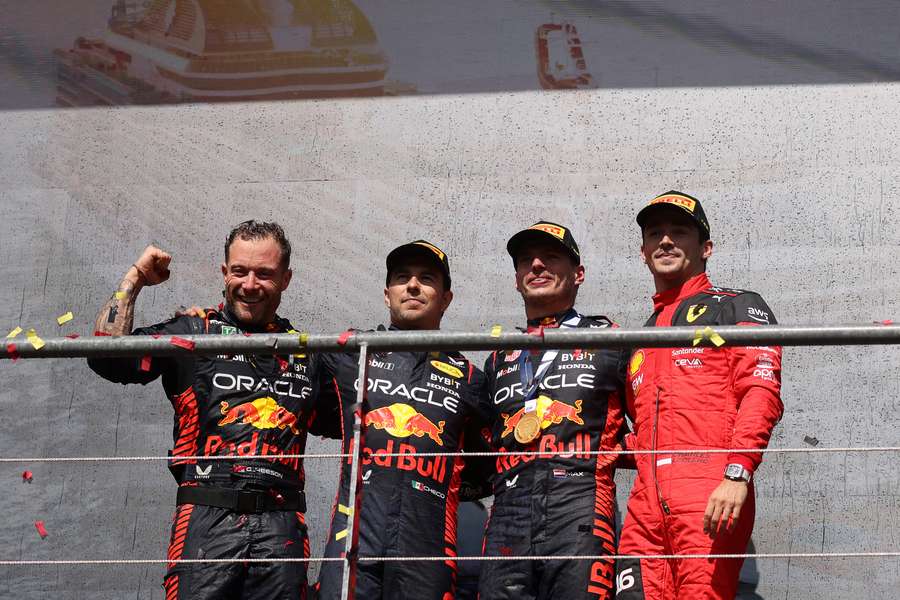 Winner Red Bull's Max Verstappen (2R, second-placed Red Bull's Sergio Perez (2L) and third-placed Ferrari's Charles Leclerc (R) pose on the podium