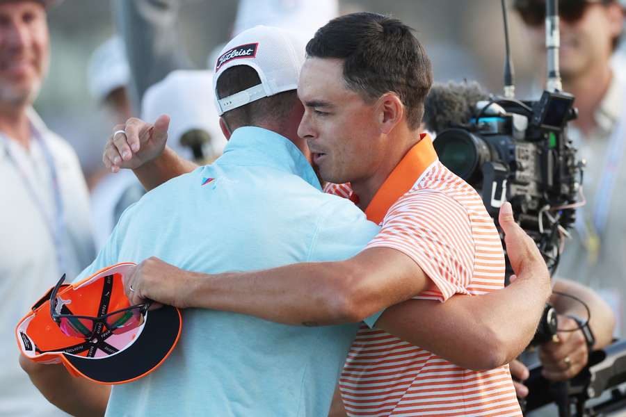 Wyndham Clark of the United States reacts to his winning putt with Rickie Fowler of the United States on the 18th green