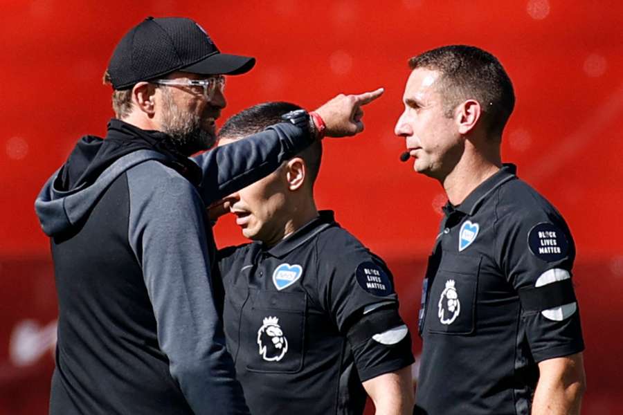 Jurgen Klopp, left speaks to referee David Coote after the English Premier League football match between Liverpool and Burnley