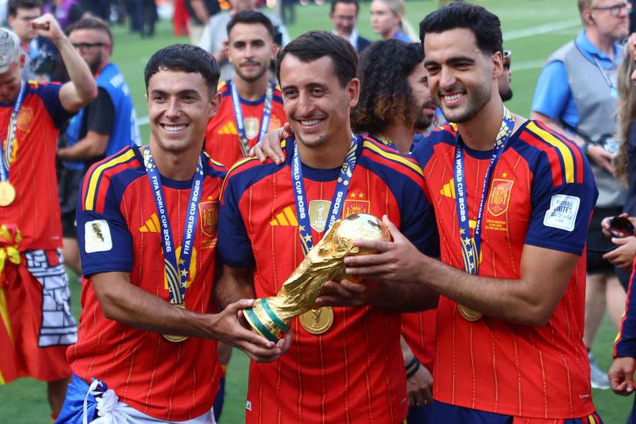Spain's Martin Zubimendi, Mikel Oyarzabal and Mikel Merino celebrate with the trophy after winning the World Cup
