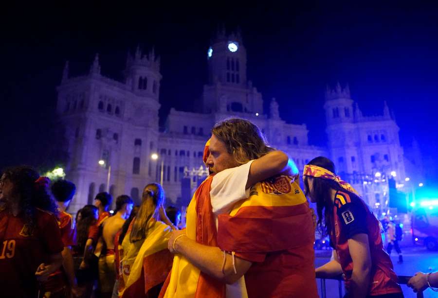 Spain fans embrace after the final Spain fans embrace after the final