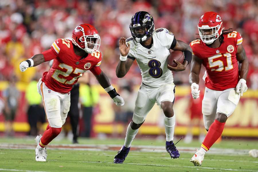 Ravens QB Lamar Jackson chased by Chiefs defenders Chamarri Conner (left) and Mike Danna (right) 
