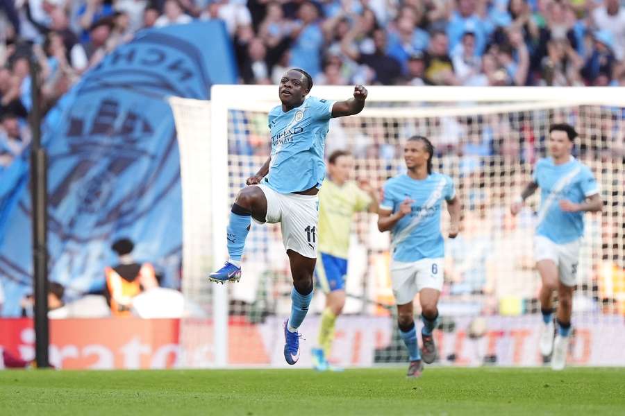 Jeremy Doku celebrates scoring Man City's equalising goal