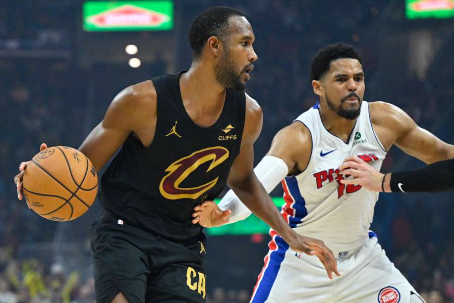 Cleveland Cavaliers center Evan Mobley dribbles beside Detroit Pistons forward Tobias Harris