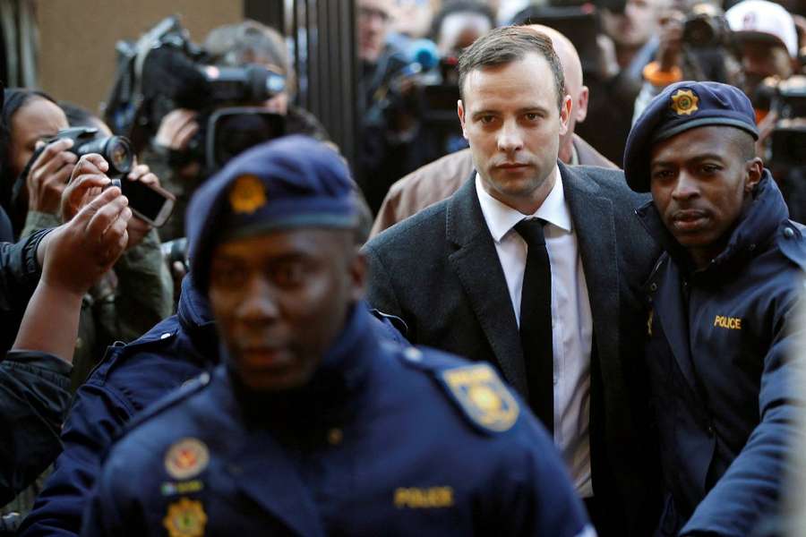 Olympic and Paralympic track star Oscar Pistorius is escorted by police officers as he arrives for his sentencing in 2016