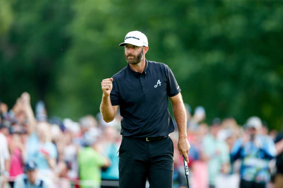 Dustin Johnson celebrates after making a birdie