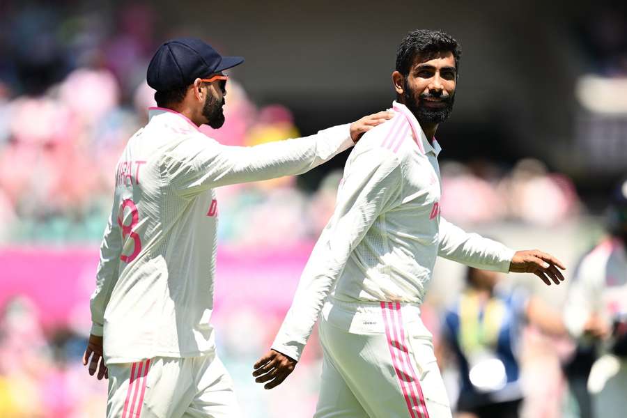 Virat Kohli (L) and Jasprit Bumrah of India 