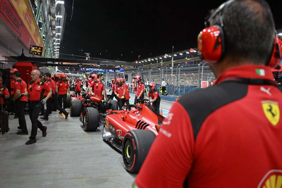 Ferrari's team work away in the pits during Singapore practice