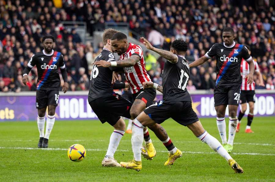 Toney battles for the ball against the Crystal Palace defenders