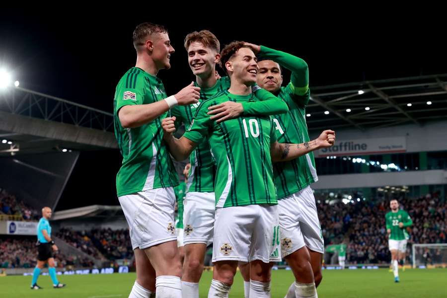 Northern Ireland's Dion Charles (centre) celebrates scoring their side's second goal