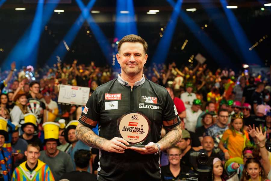 Woodhouse poses with the Baltic Sea Darts Open trophy
