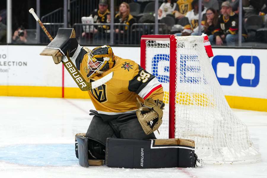 Golden Knights goaltender Laurent Brossoit attempts to deflect a Seattle Kraken shot 