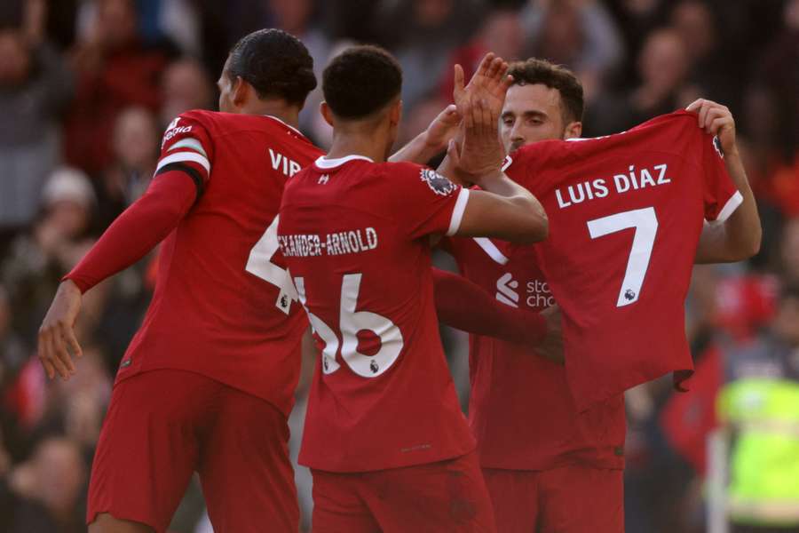 Liverpool's Diogo Jota shows off a shirt with the name of teammate Luis Diaz as he celebrates after scoring the opening goal