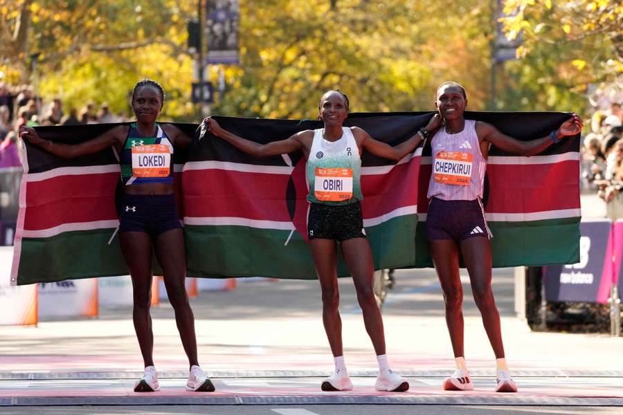 Kenya's Hellen Obiri celebrates after winning the women's race alongside Sharon Lokedi and Sheila Chepkirui Kenya's Hellen Obiri celebrates after winning the women's race alongside Sharon Lokedi and Sheila Chepkirui