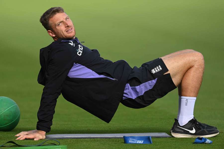 Jos Buttler stretches during an England training session