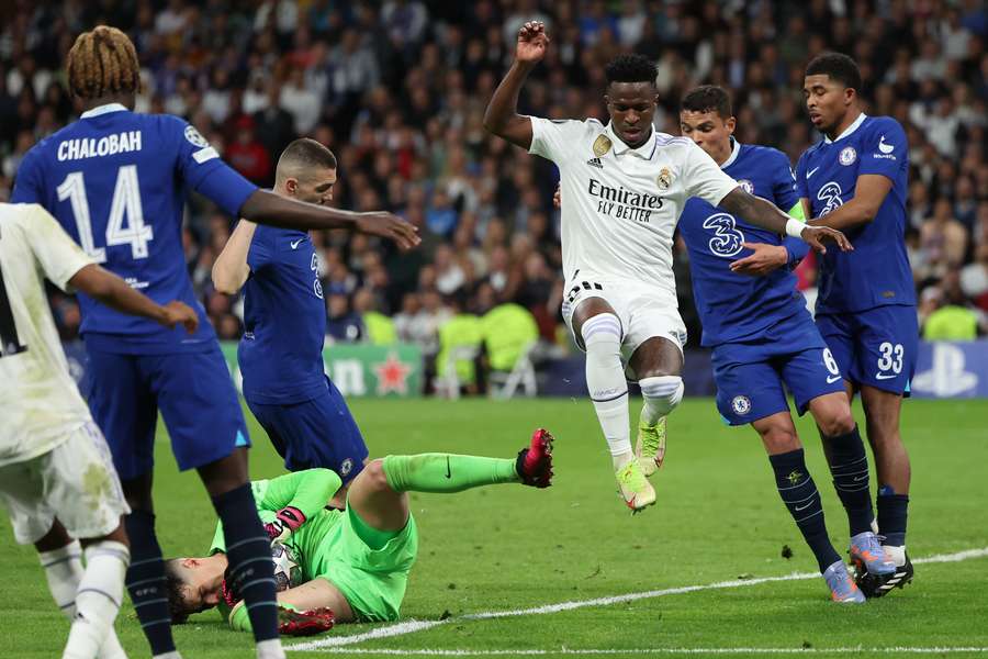 Real Madrid's Brazilian forward Vinicius Junior jumps as Chelsea's Spanish goalkeeper Kepa Arrizabalaga makes a save