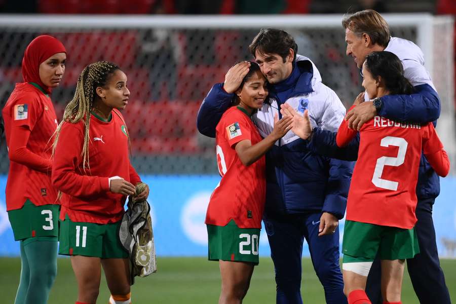 Morocco's coach Reynald Pedros (R) consoles Morocco players
