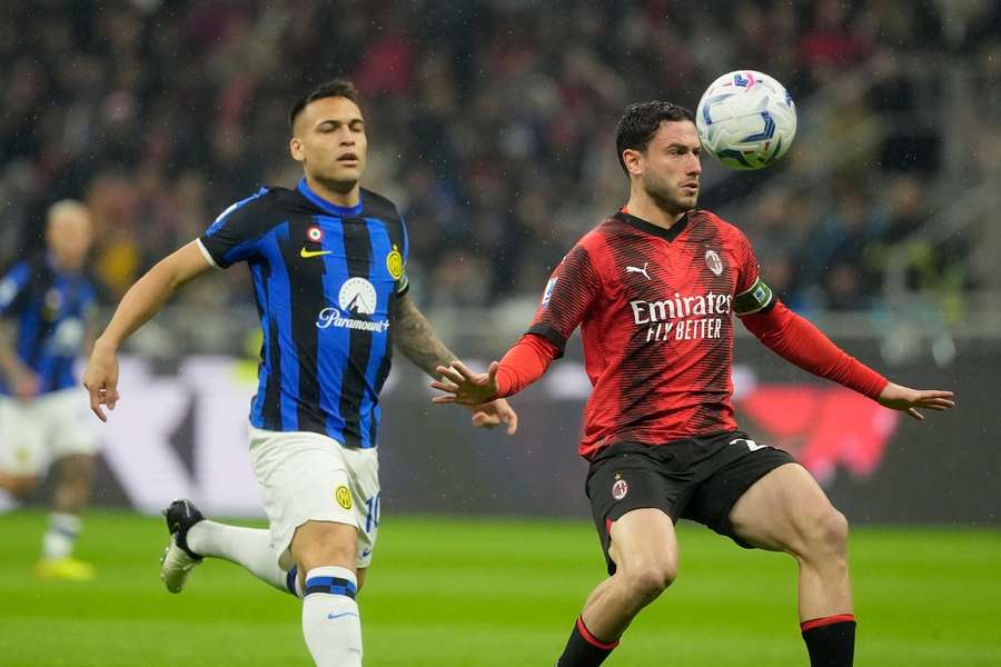 AC Milan's Davide Calabria, right, is challenged by Inter Milan's Lautaro Martinez