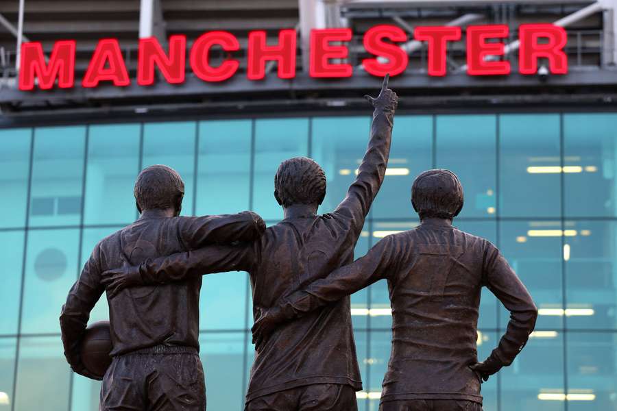 The statues of Sir Bobby Charlton, George Best and Denis Law are seen outside Old Trafford